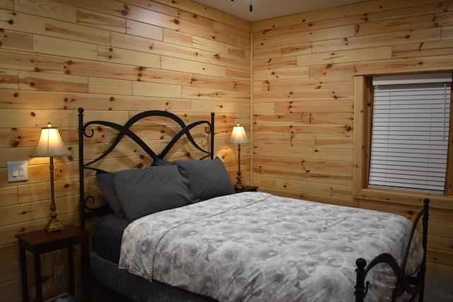 bedroom featuring wooden walls