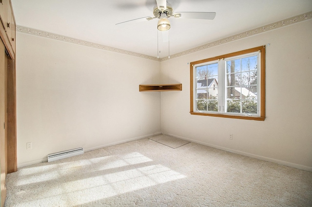 empty room with baseboard heating, light colored carpet, and ceiling fan