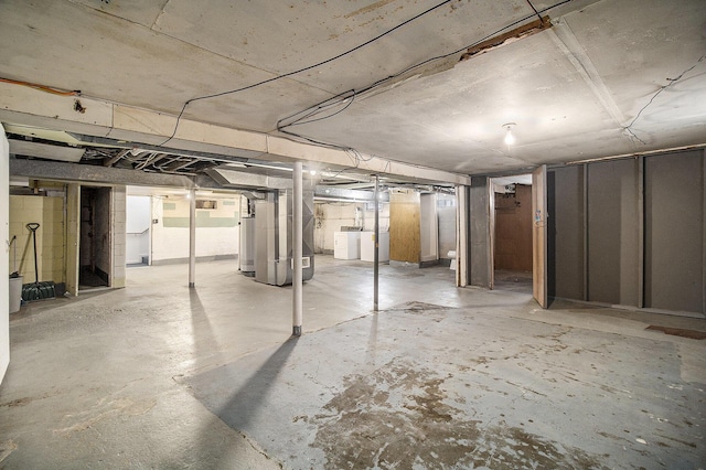 basement with washer / clothes dryer, heating unit, and gas water heater