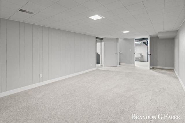 basement featuring carpet and a drop ceiling