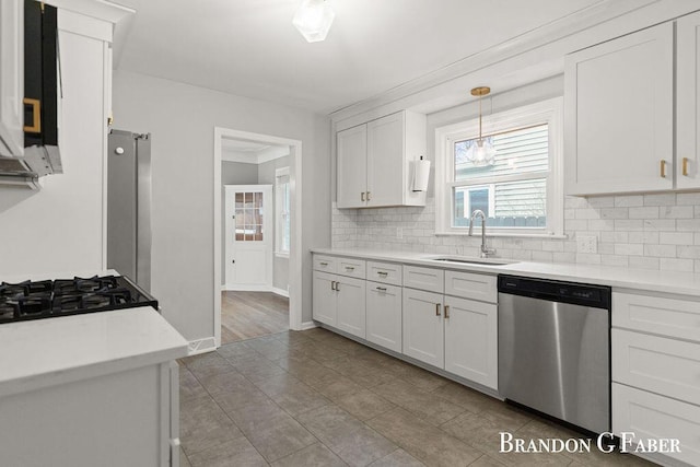 kitchen with sink, dishwasher, white cabinetry, backsplash, and hanging light fixtures