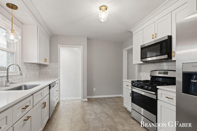 kitchen featuring sink, white cabinetry, pendant lighting, stainless steel appliances, and decorative backsplash