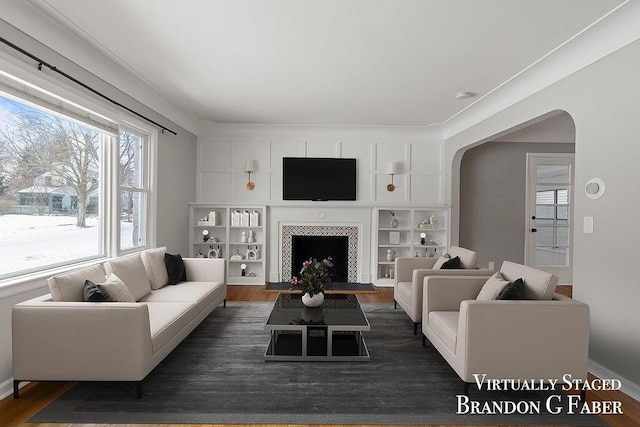 living room with a fireplace and dark hardwood / wood-style flooring