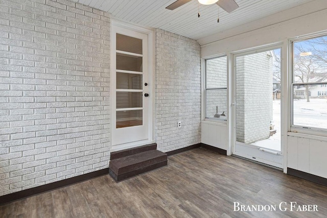 unfurnished sunroom with ceiling fan and wooden ceiling