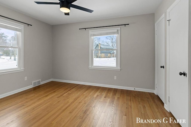 empty room featuring ceiling fan and light wood-type flooring