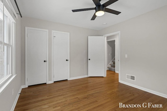 unfurnished bedroom with wood-type flooring and ceiling fan