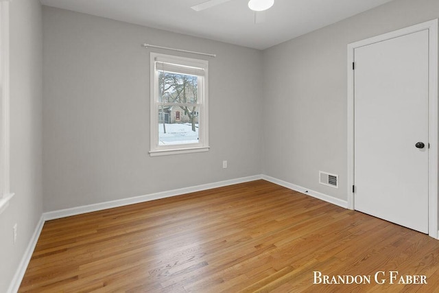 empty room featuring ceiling fan and light wood-type flooring