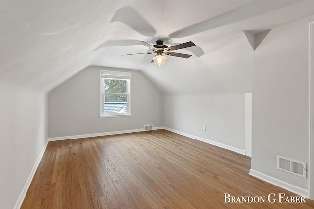 additional living space featuring hardwood / wood-style flooring, ceiling fan, and vaulted ceiling