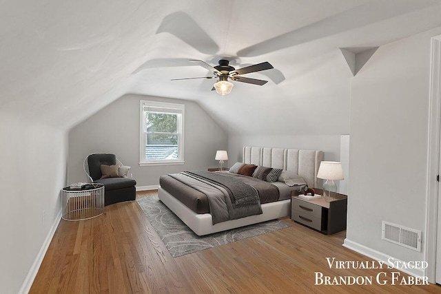 bedroom featuring ceiling fan, vaulted ceiling, and light hardwood / wood-style flooring