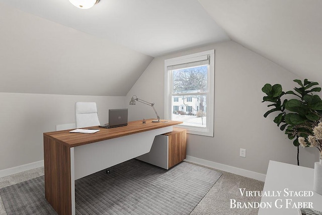 home office featuring lofted ceiling and carpet floors