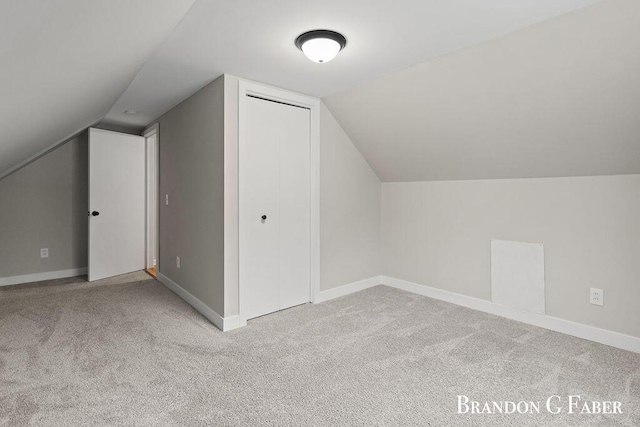 bonus room featuring light colored carpet and lofted ceiling