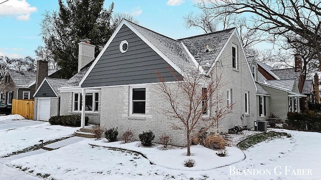 view of snowy exterior featuring central AC