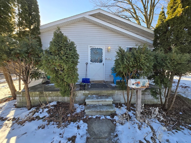 view of snow covered property entrance