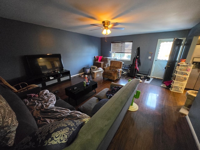 living room with dark hardwood / wood-style flooring and ceiling fan