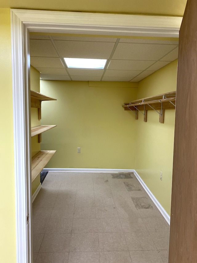 spacious closet with a paneled ceiling