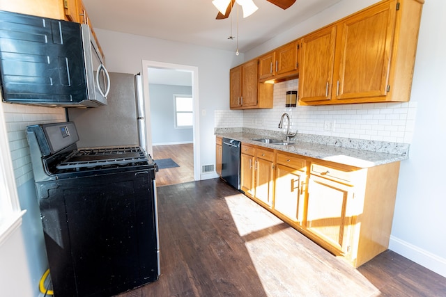 kitchen featuring sink, dark wood-type flooring, ceiling fan, backsplash, and black appliances