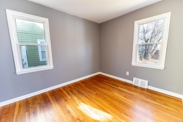 unfurnished room with wood-type flooring