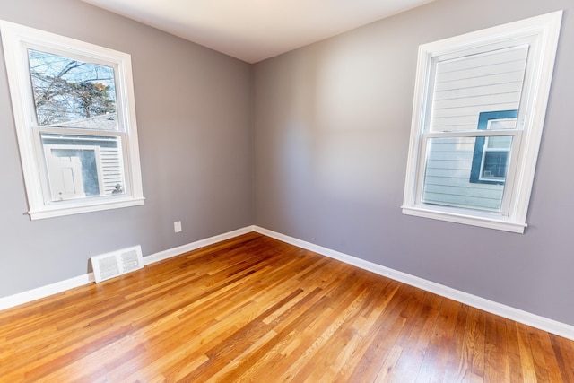 unfurnished room featuring hardwood / wood-style flooring