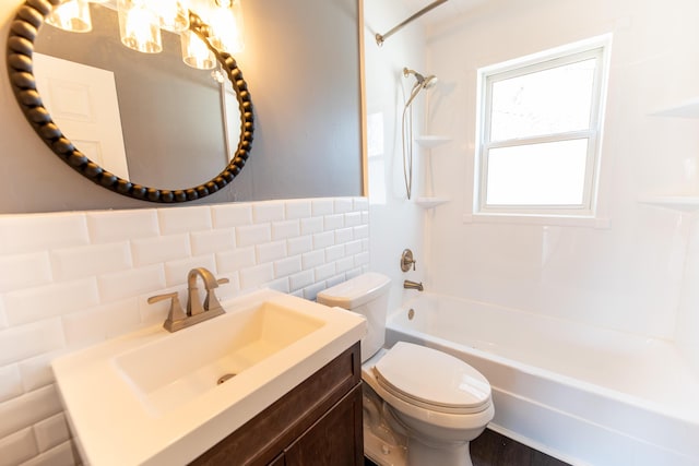 full bathroom featuring bathtub / shower combination, vanity, toilet, and tile walls