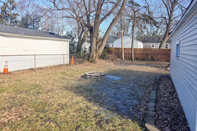 view of yard with a fire pit