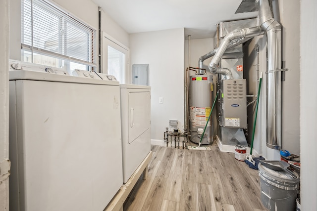 utility room featuring independent washer and dryer, electric panel, and water heater