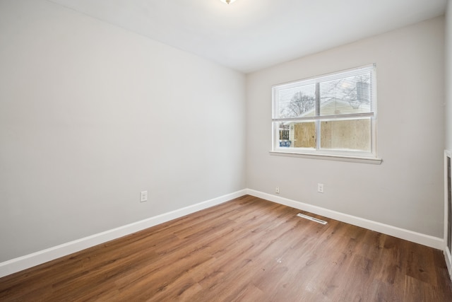 unfurnished room featuring hardwood / wood-style floors