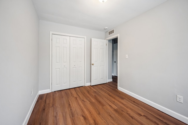 unfurnished bedroom featuring hardwood / wood-style flooring and a closet