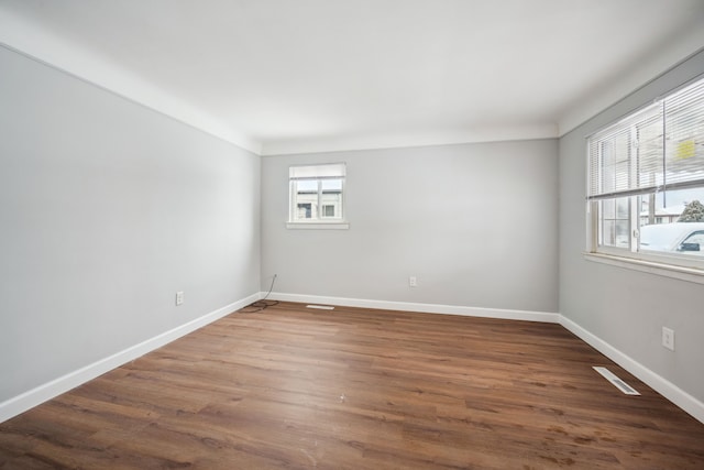 empty room featuring dark wood-type flooring