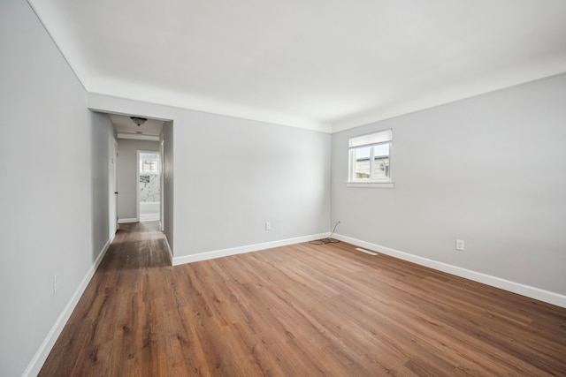 empty room with hardwood / wood-style flooring