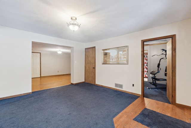 spare room featuring dark wood-type flooring