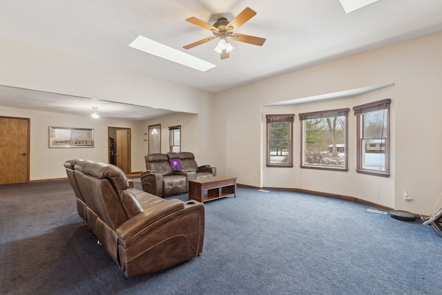 carpeted living room with a skylight and ceiling fan