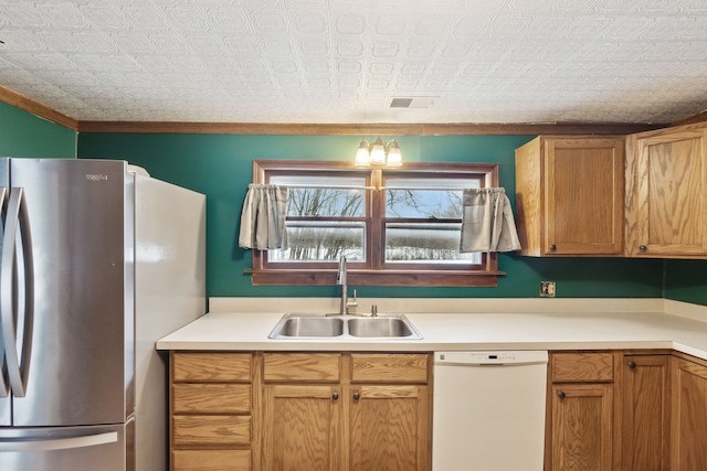 kitchen with dishwasher, sink, stainless steel fridge, and crown molding