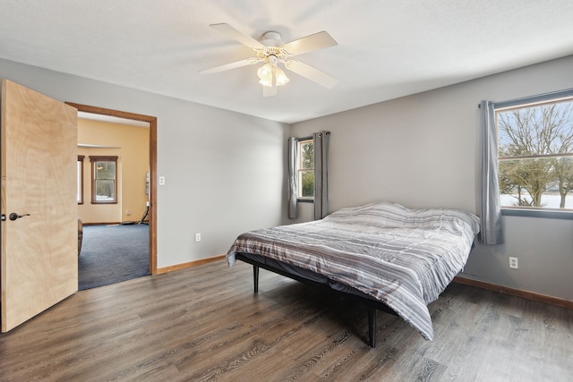 bedroom with ceiling fan and dark hardwood / wood-style flooring