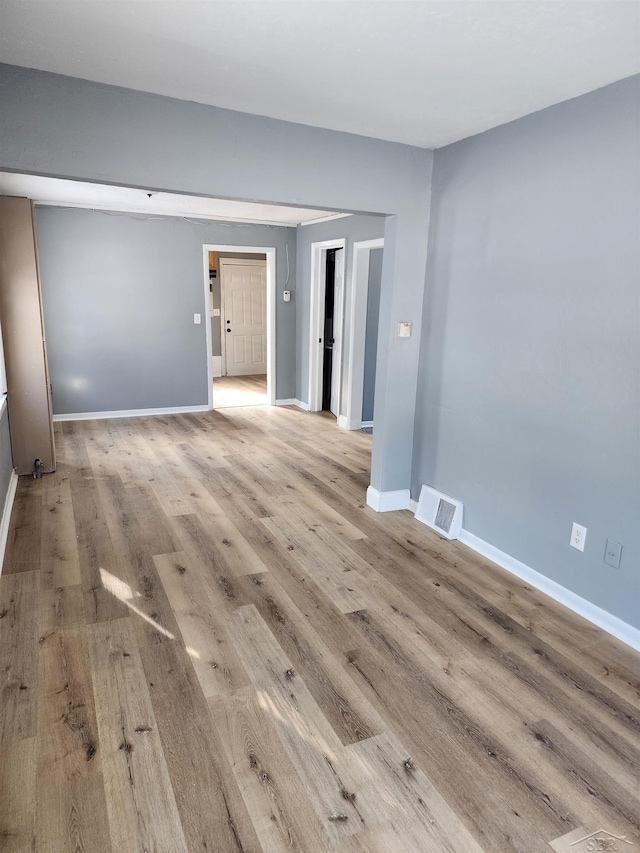 empty room with light hardwood / wood-style floors