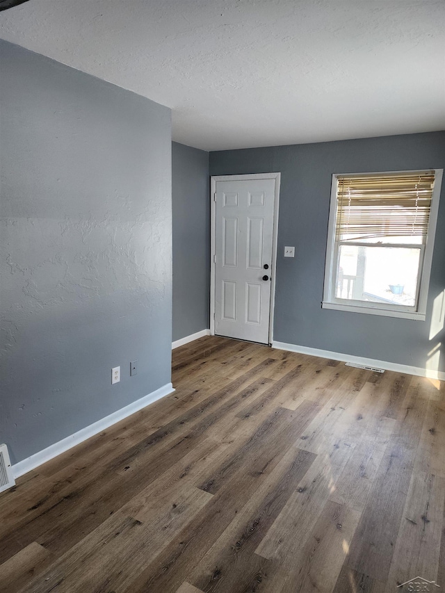 foyer with hardwood / wood-style flooring and a textured ceiling