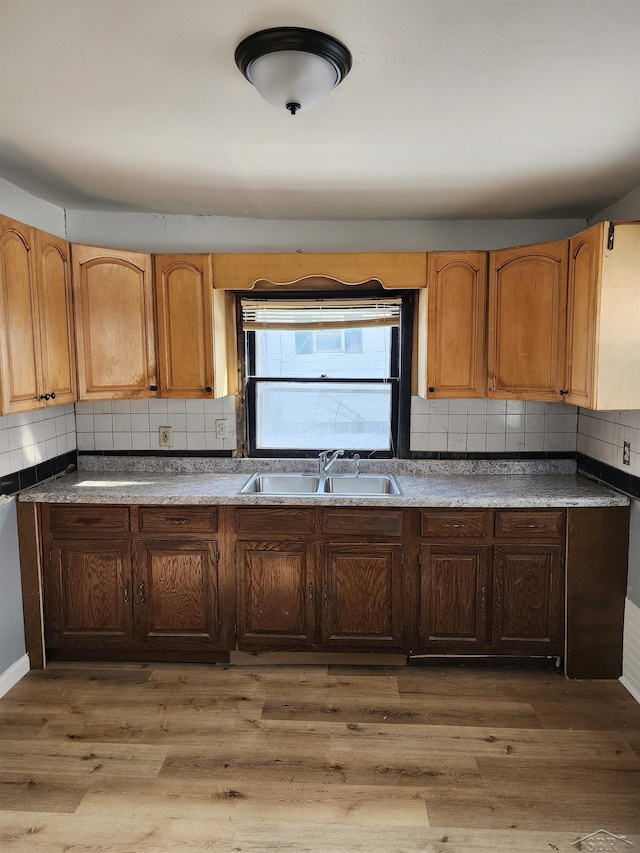 kitchen featuring dark hardwood / wood-style flooring, sink, and backsplash