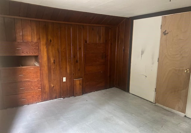 spare room featuring wood ceiling, lofted ceiling, and wood walls