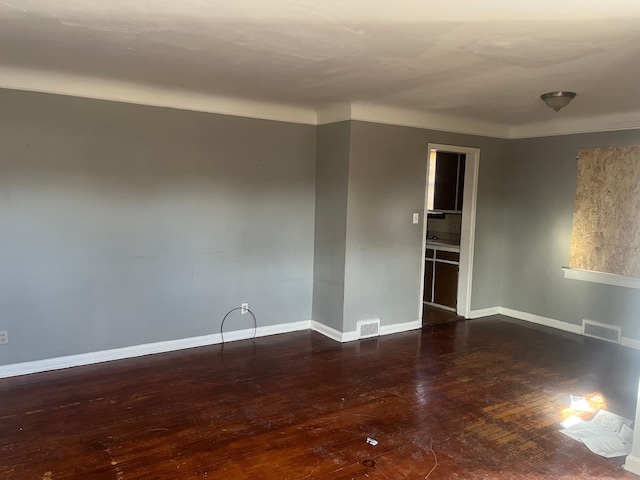 spare room with dark wood-type flooring