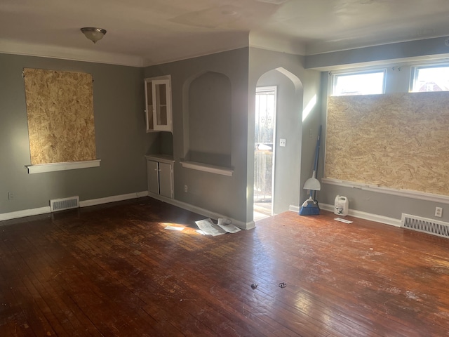 unfurnished room with dark wood-type flooring