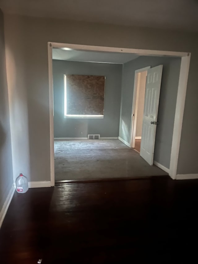 unfurnished room with hardwood / wood-style flooring