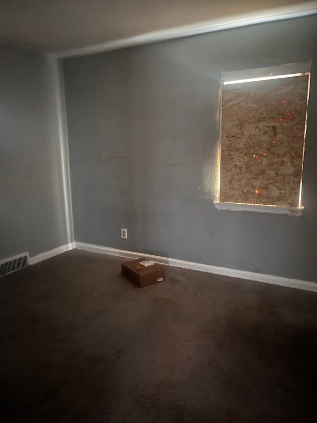 unfurnished room featuring concrete floors