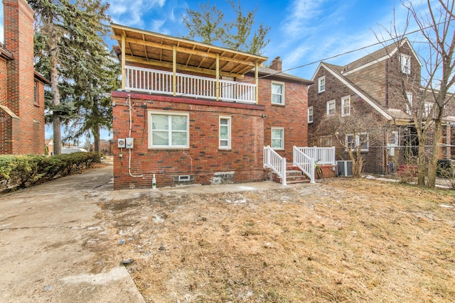 rear view of property with a balcony and central air condition unit