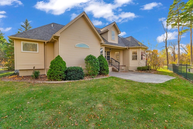 rear view of property with a patio and a lawn