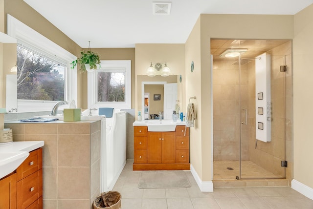 bathroom with vanity, tile patterned flooring, and walk in shower