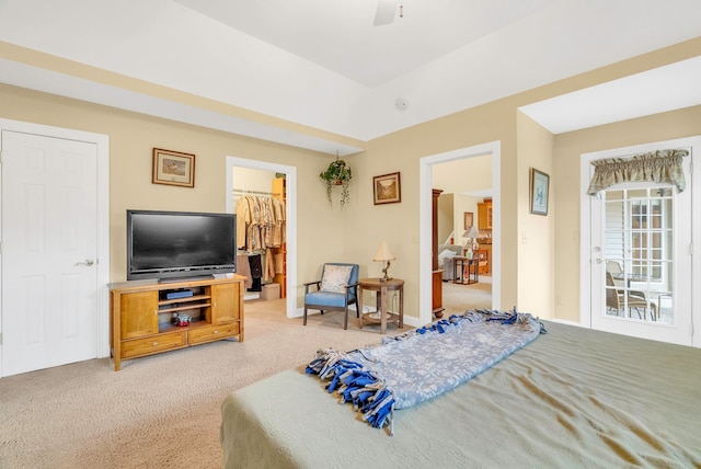 carpeted bedroom featuring a spacious closet and ceiling fan