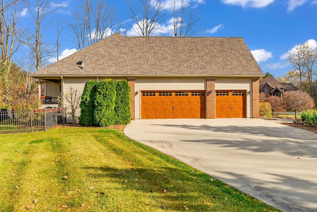 view of front of home featuring a garage and a front lawn