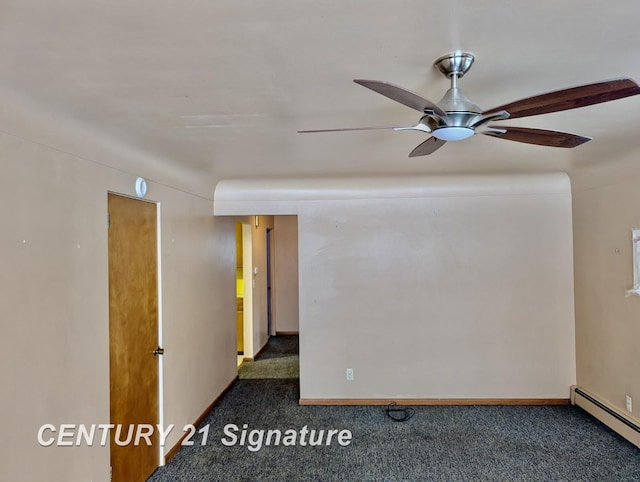 spare room with baseboard heating, ceiling fan, and dark colored carpet