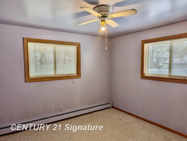 spare room with a baseboard heating unit, baseboards, carpet floors, and ceiling fan