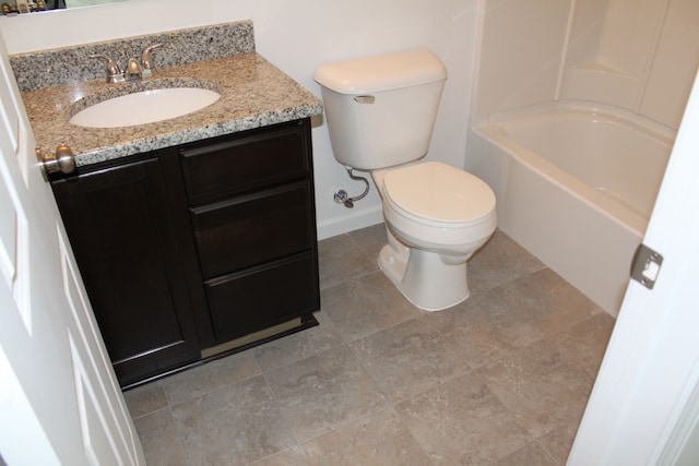 bathroom featuring tile patterned floors, vanity, and toilet