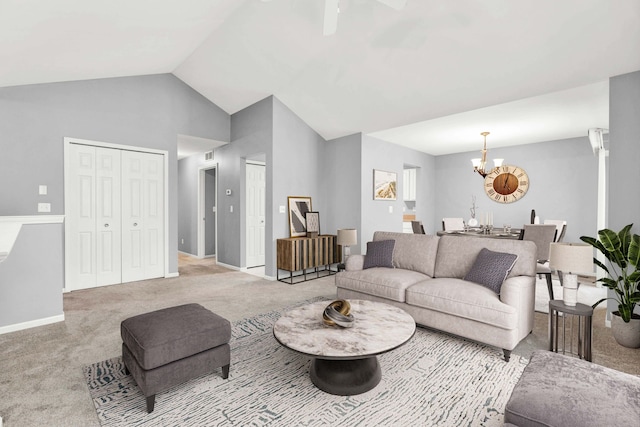 living room with a notable chandelier, vaulted ceiling, and light colored carpet